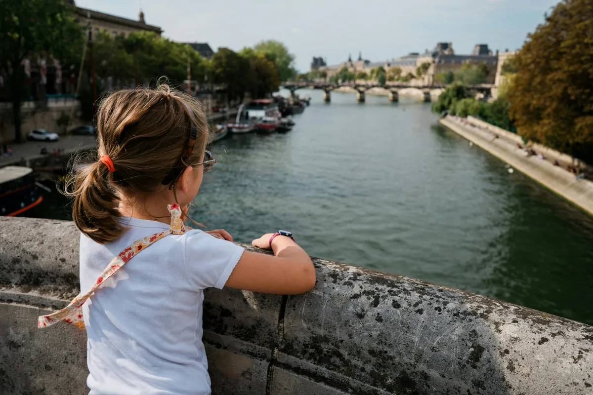 Talent Passport family residence permit: a child looks over the Seine in Paris
